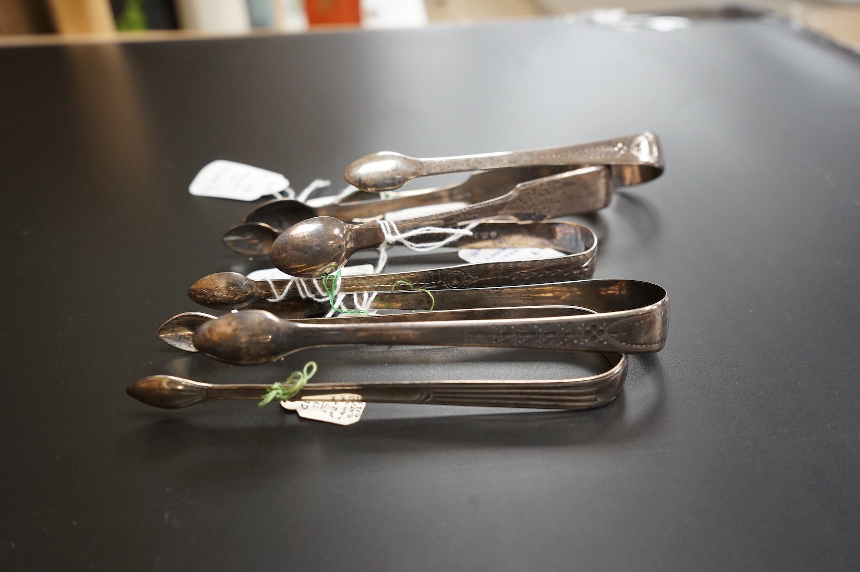 Five assorted pairs of Georgian silver sugar tongs, including four George III, one by Peter & Ann Bateman, London, 1797 largest 13.3cm.